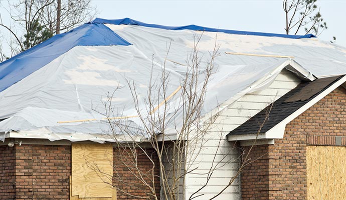 White and blue tarp over the roof