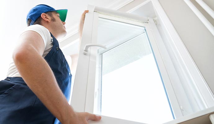 professional handyman installing window at home