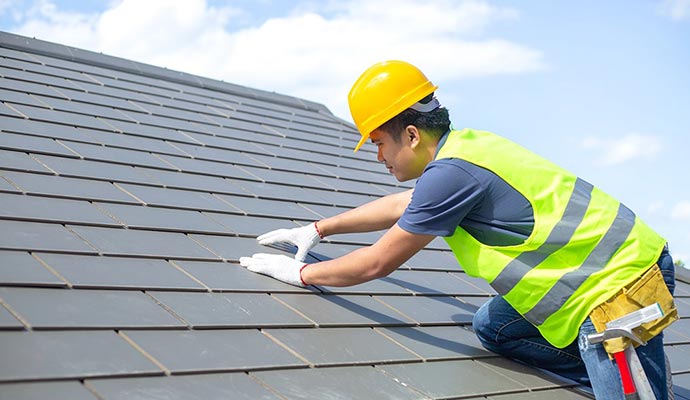 worker installing roof